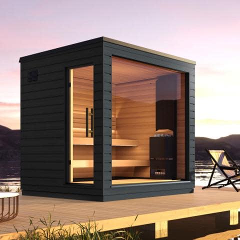 Modern outdoor sauna with wooden interior and black exterior on a deck with scenic background