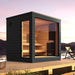 Modern outdoor sauna with wooden interior and black exterior on a deck with scenic background